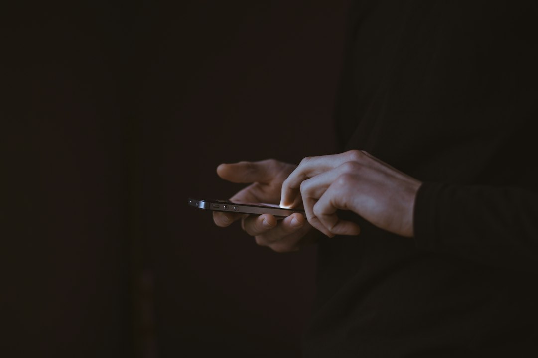 Silhouette of a person holding a smartphone, representing the new Lava Agni 4N challenger phone versus unboxed flagship options