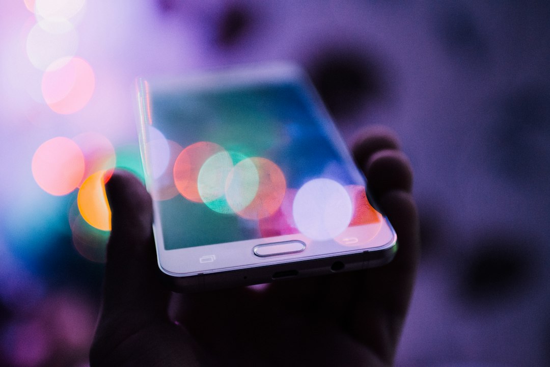 Person holding a smartphone, representing the rising cost of buying a phone in India