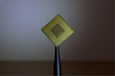 Computer processor chip held by tweezers, representing Nvidia's new RTX Spark AI PC platform