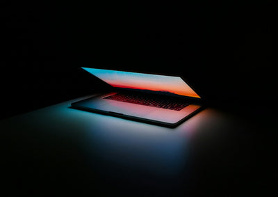 A laptop resting on a desk, representing the choice between a cloud PC subscription and owning a refurbished laptop