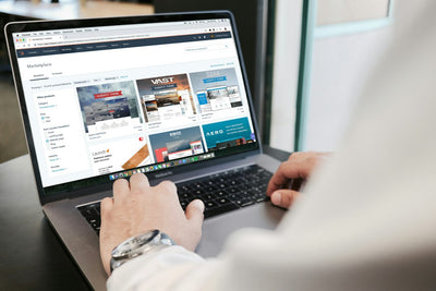 Person using a laptop to shop online during a festival sale