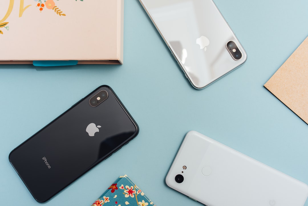 Space gray iPhone lying on a table, representing the choice between a new iPhone 18 Pro and an unboxed previous-generation iPhone