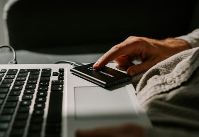Person using a laptop, representing the SSD and storage price surge affecting laptop buyers in 2026