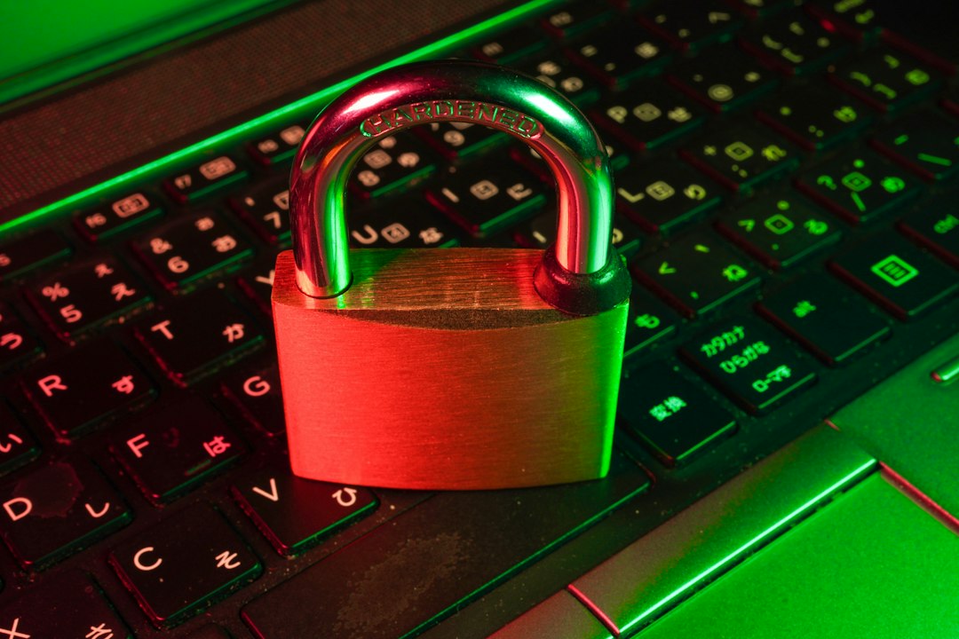 Red padlock resting on a laptop keyboard, symbolizing data privacy and security concerns around Windows features
