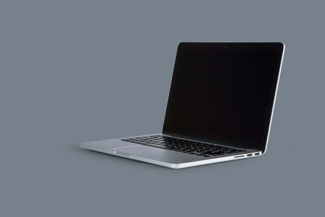 An open laptop on a table, representing a used device ready for trade-in or resale