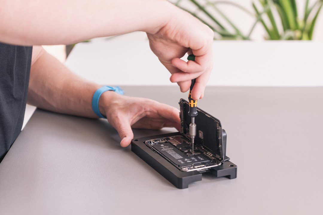 Technician performing a device repair, illustrating laptop repairability