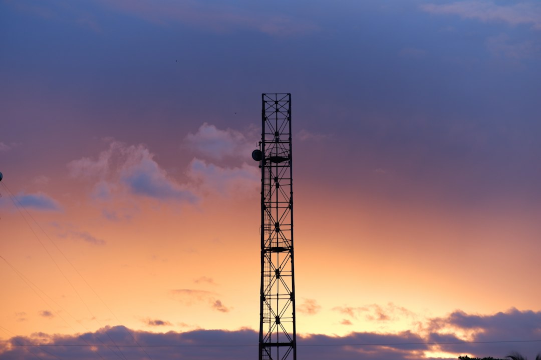 Telecom tower silhouetted against a sunset sky, representing India's 5G and 6G network expansion